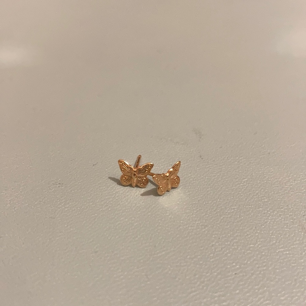 14 karat yellow gold tiny butterfly stud earrings.